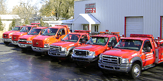 Trucks lined up in front of building angled view.